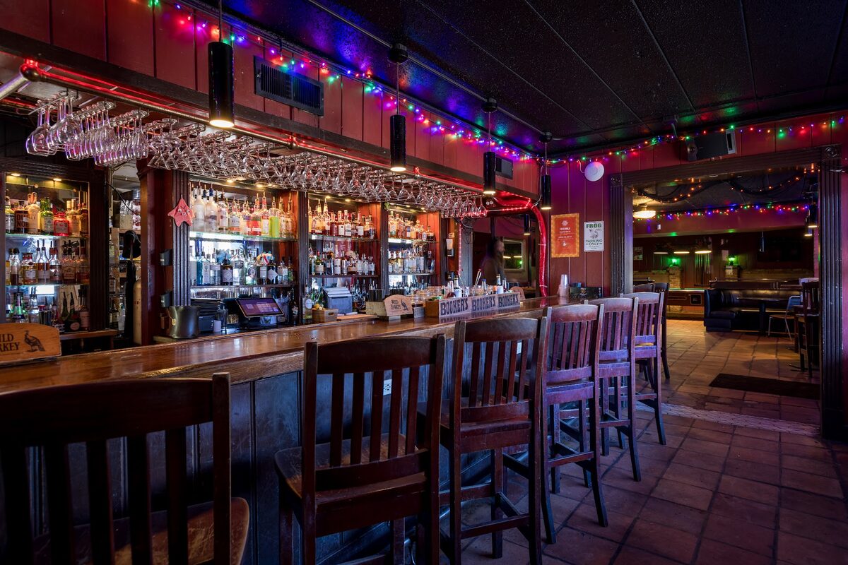 The back bar at Duvic's Martini Bar, lined with bottles and string lights