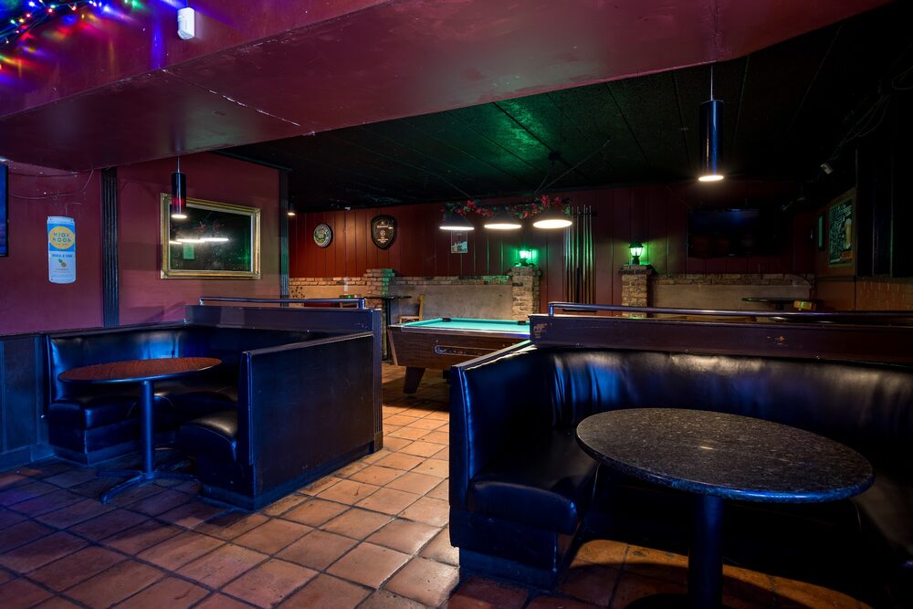 Booth seating and the pool table inside Duvic's